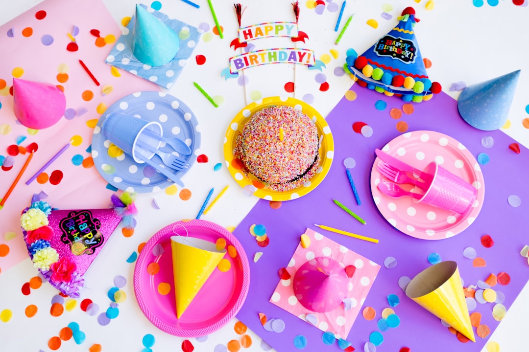 A variety of creative and practical party favors displayed on a table, including small plants, personalized items, and themed gifts.